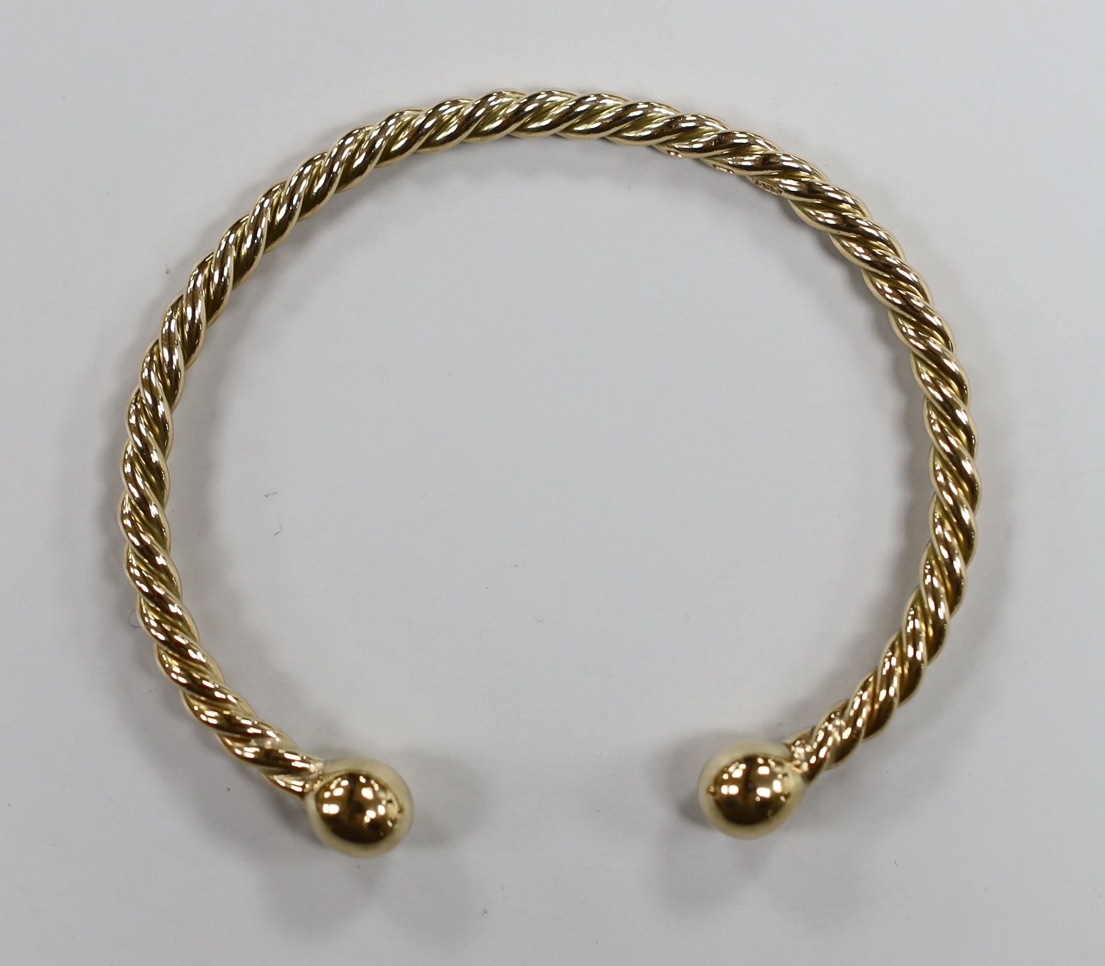 A modern 9ct gold rope twist bangle, 22.1 grams.